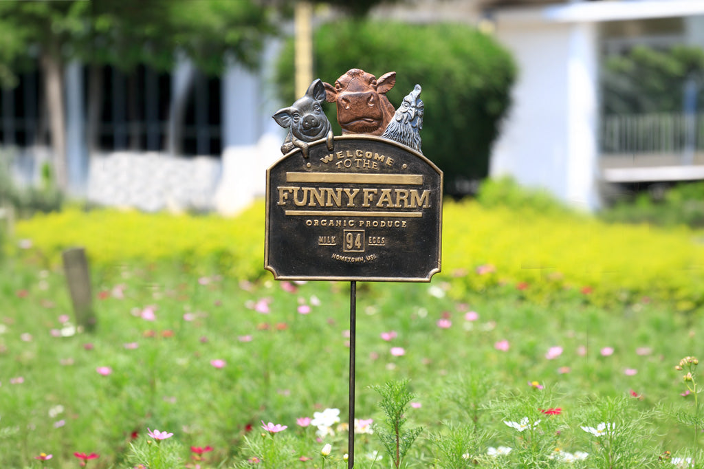 Garden sign with 'Funny Farm' branding in a grassy area