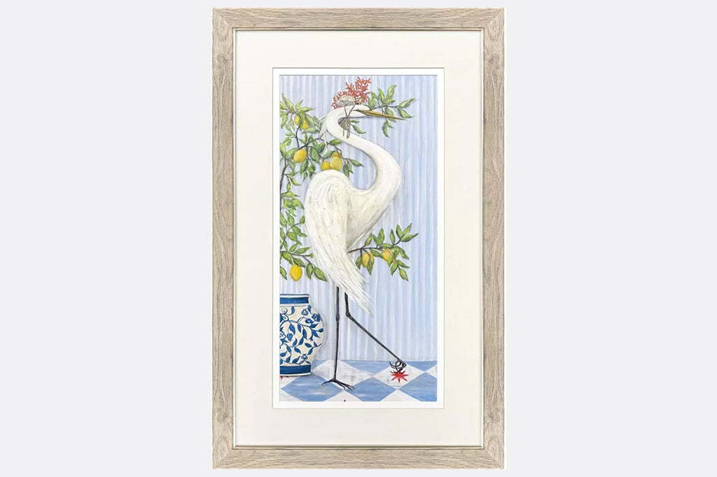 Framed artwork of cranes wearing crowns made of coral next to fruit trees.