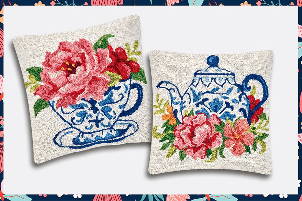 Two hooked wool pillows featuring chinoiserie blue and white teapot and tea cup with pink blossoms arrayed around