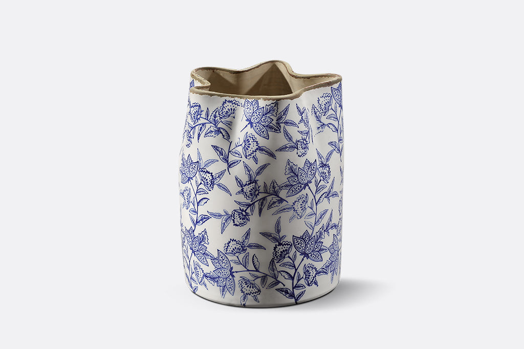 Ceramic vase with blue floral pattern on a white background