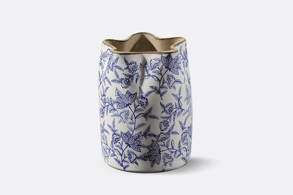 Ceramic vase with blue floral pattern on a white background