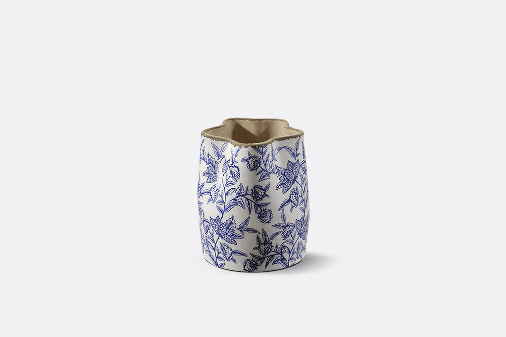 A white vase with blue floral patterns