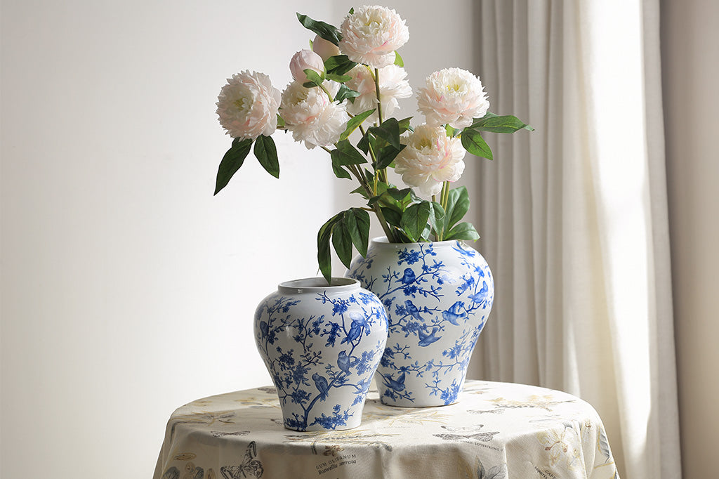 A white and blue Chinoiserie vase with bluebirds and branches