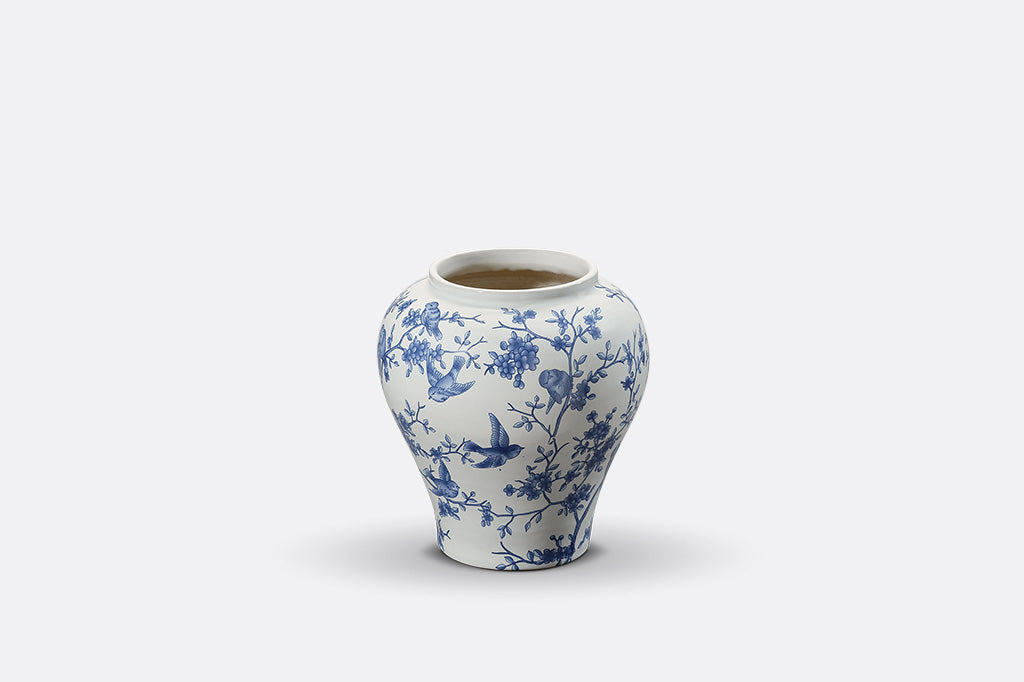 A white and blue Chinoiserie vase with bluebirds and branches