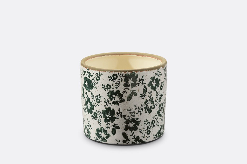 Ceramic planter with floral pattern on a white background
