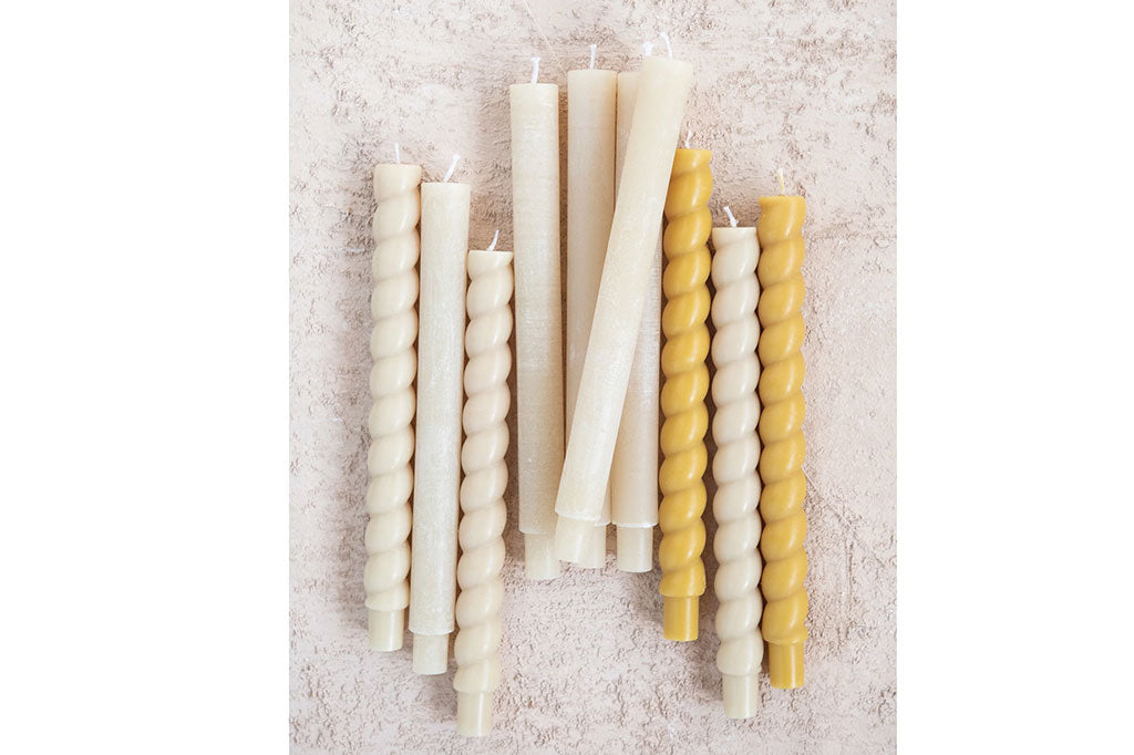 cream colored twisted taper candle, with yellow and white taper candles