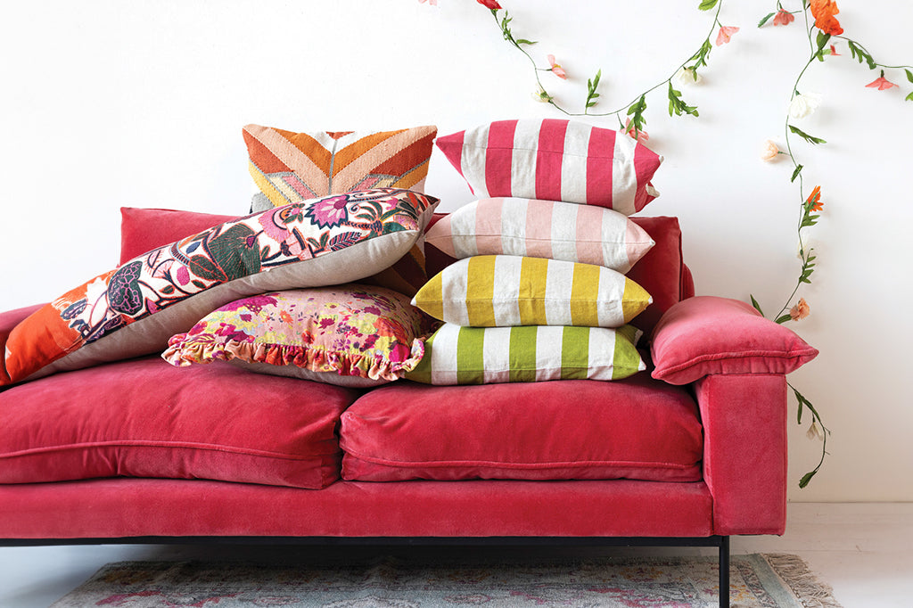 pillows staked on red couch