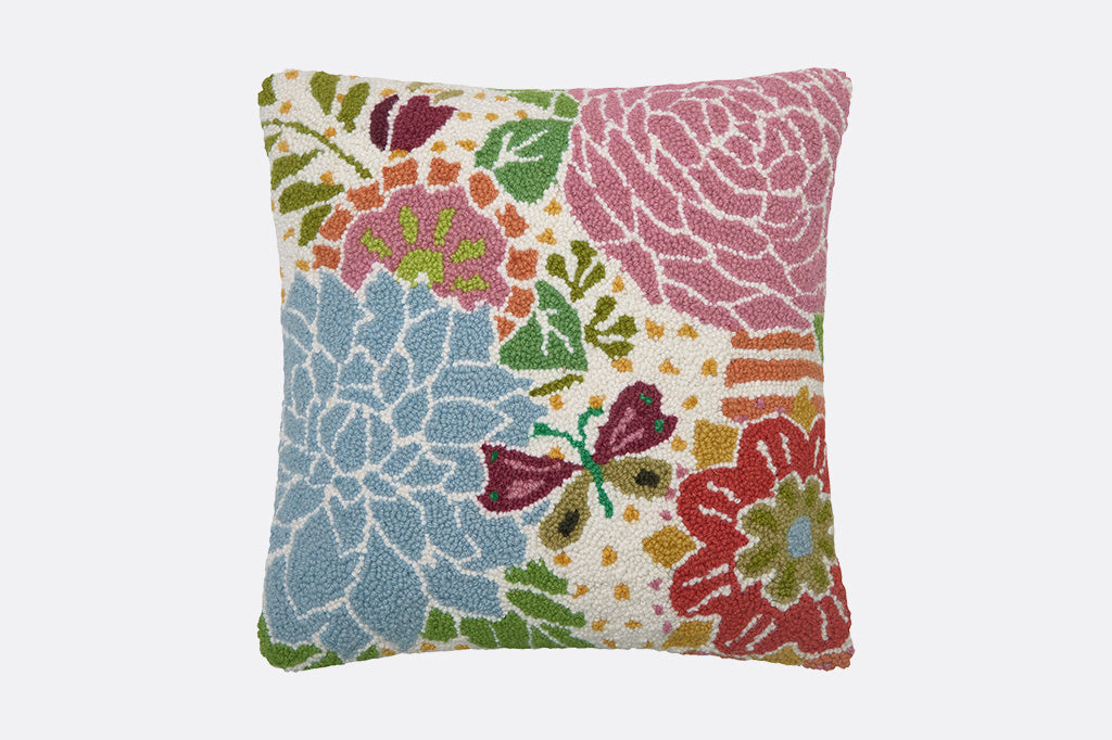 Hooked Wool throw pillow with butterfly and scattered floral print in playful shades of pink and blue