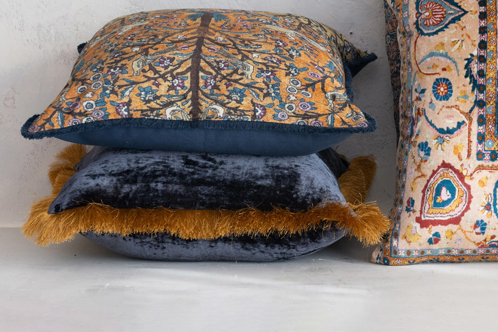 navy velvet pillow, accented with gold fringe - shown in stack with other bohemian print pillows
