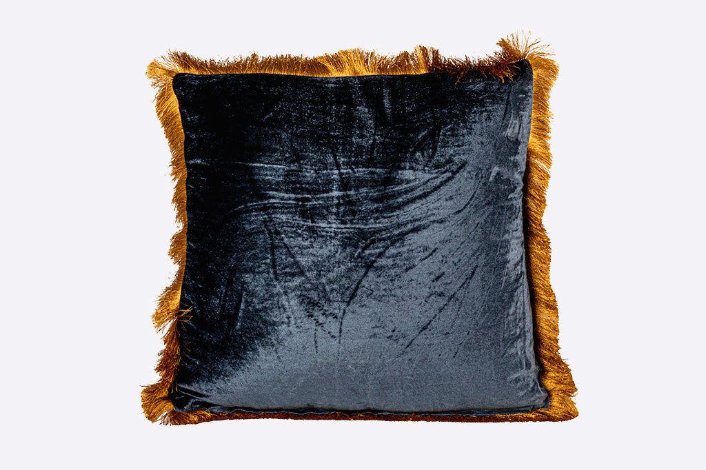 navy velvet pillow, accented with gold fringe
