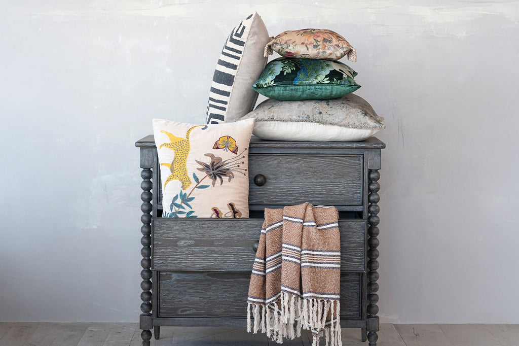 pillow stacked on cabinet