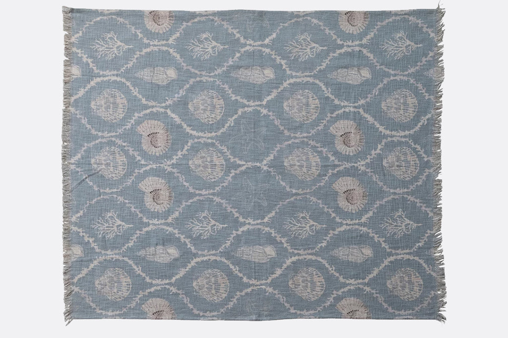 blue throw blanket with shells and coral design with tassels