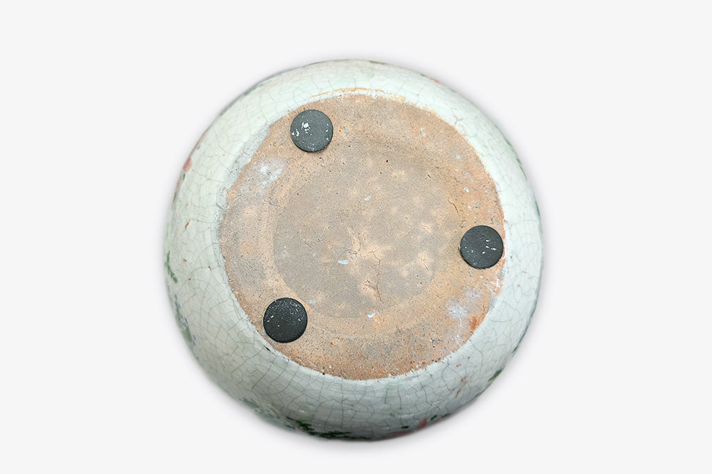 Decorative ceramic pot with colorful floral patterns on a white background