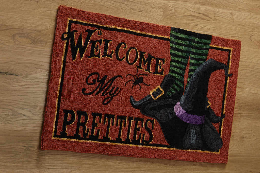 Halloween-themed doormat with a witch hat and spider design on a wooden floor.