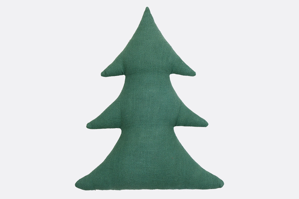 Green tree-shaped pillow on a light gray background