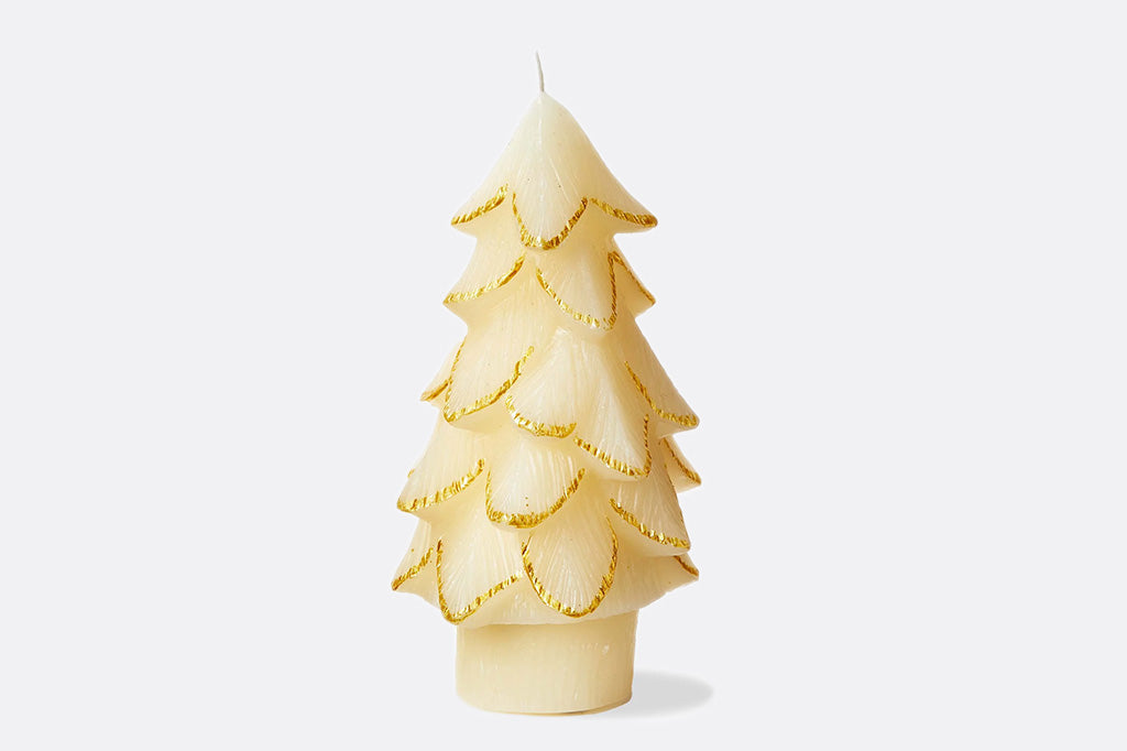 Tree-shaped candle with gold accents on a white background