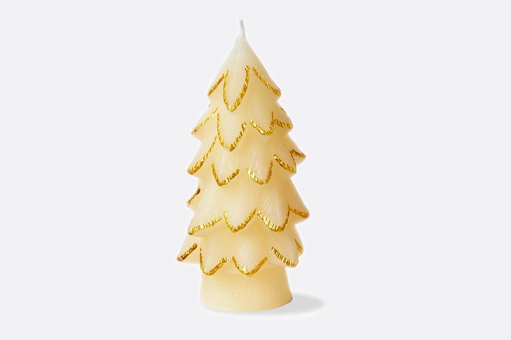Decorative candle shaped like a Christmas tree with gold accents on a white background