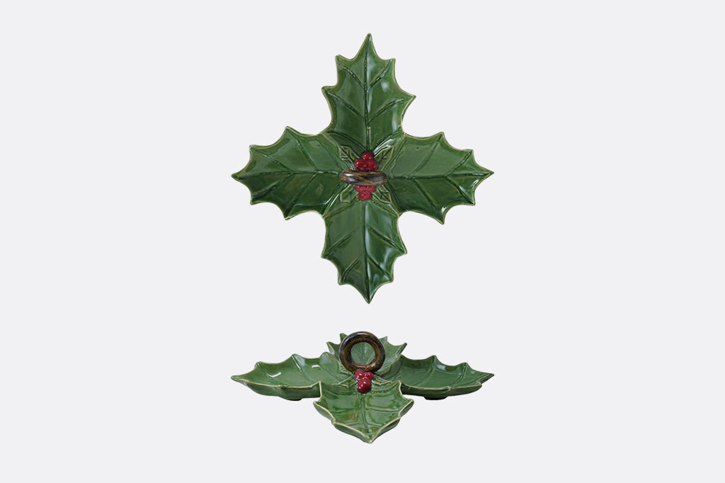 Two green holly leaf-shaped ceramic dishes on a white background; top view and side profile view shown
