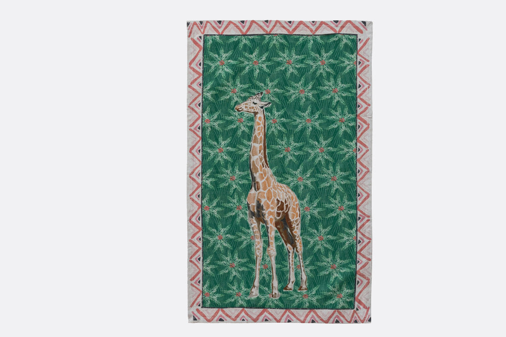 Holiday tea towel with animal illustrations and festive prints. Giraffe
