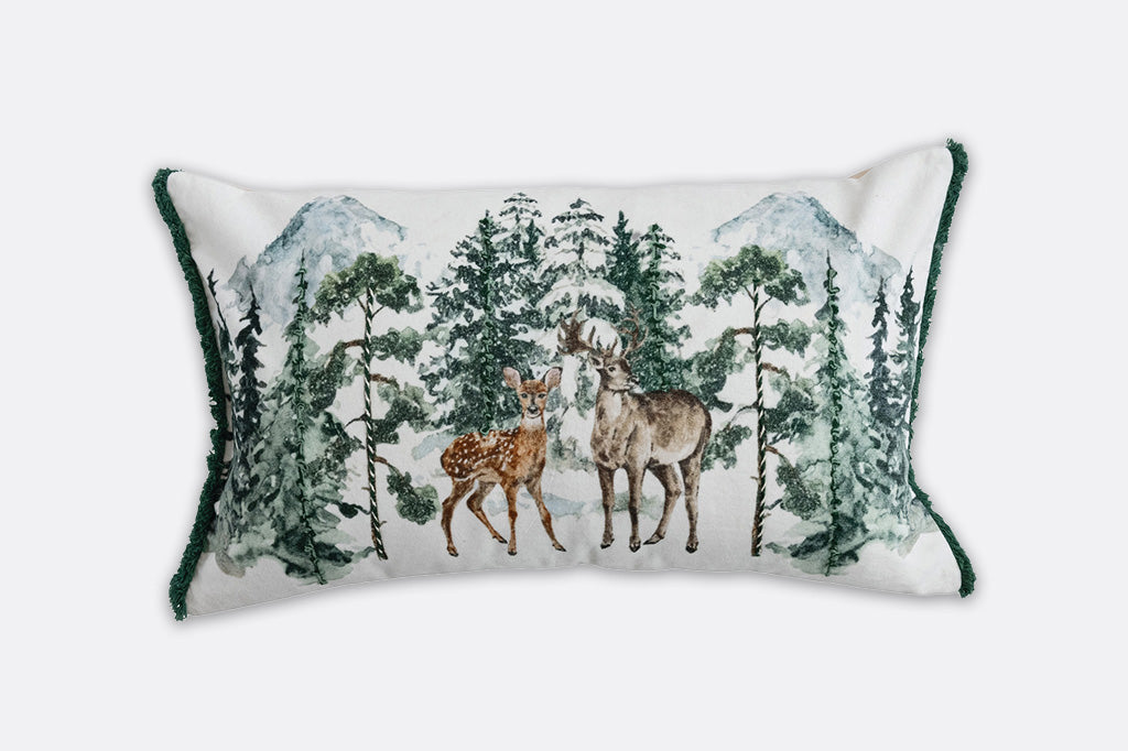 Decorative pillow with deer and forest design on a white background