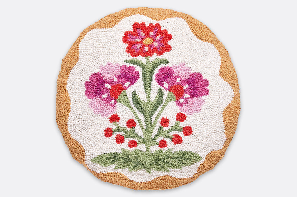 A circle hooked pillow with floral designs