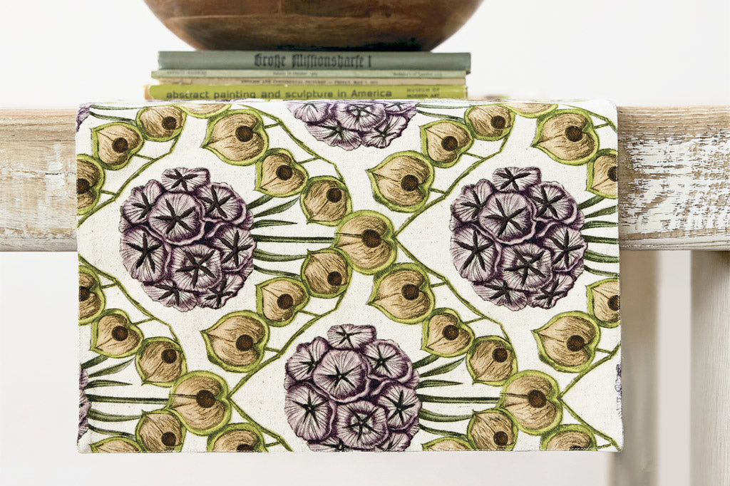 Table runner with floral phlox pattern on a wooden surface