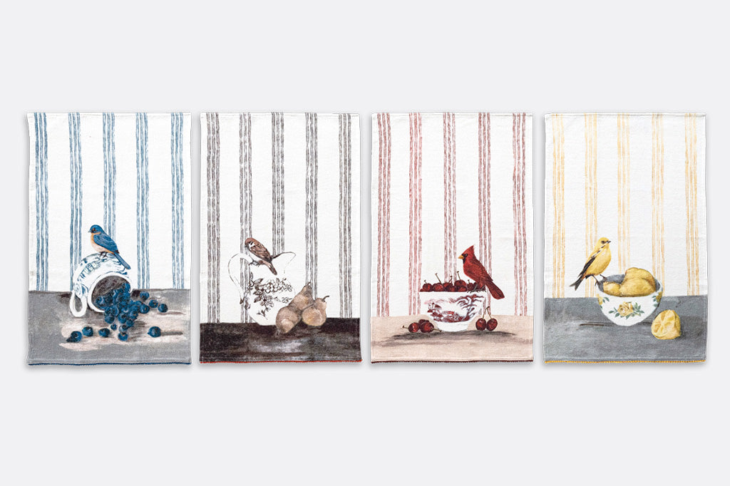 A set of four tea towels with red blue, yellow, and brown stripes. Each Towel features a bird stood upon a pile of assorted fruits.