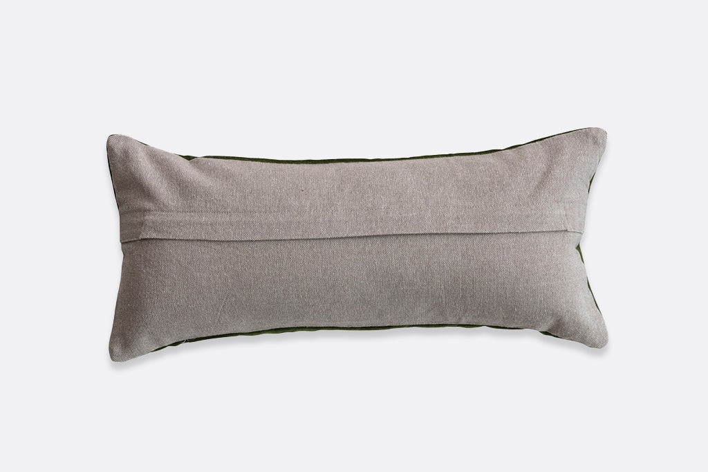 A green pillow with a beige back that has vibrantly colored butterflies embroidered onto it.