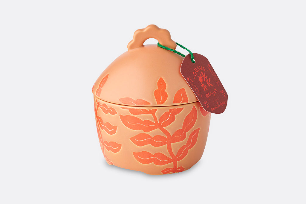 A soft orange guava shaped candle.