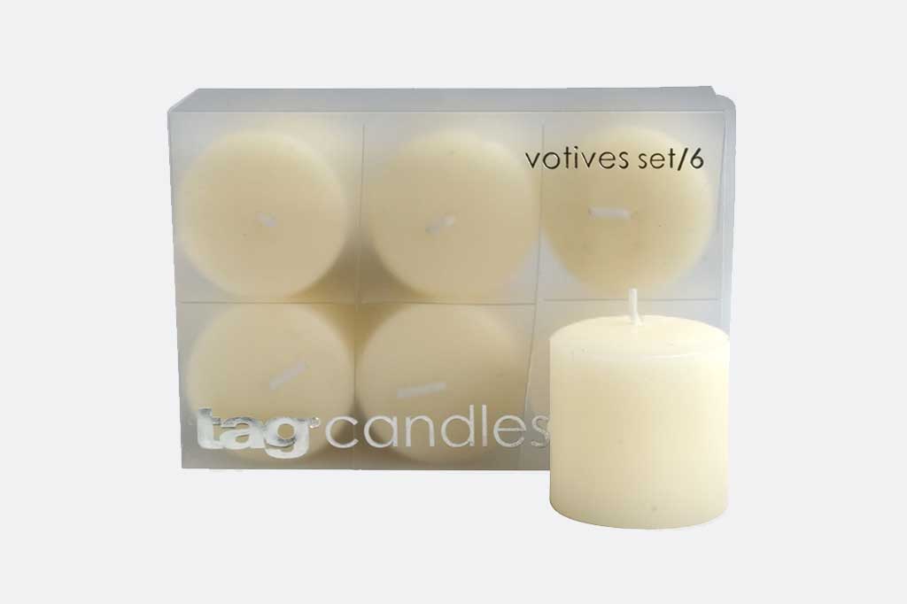6 ivory-colored votive candles in a package on white background