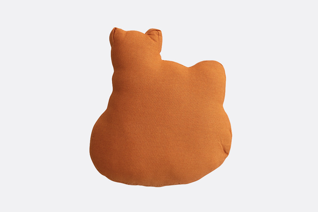 Orange cat-shaped cushion on a white background