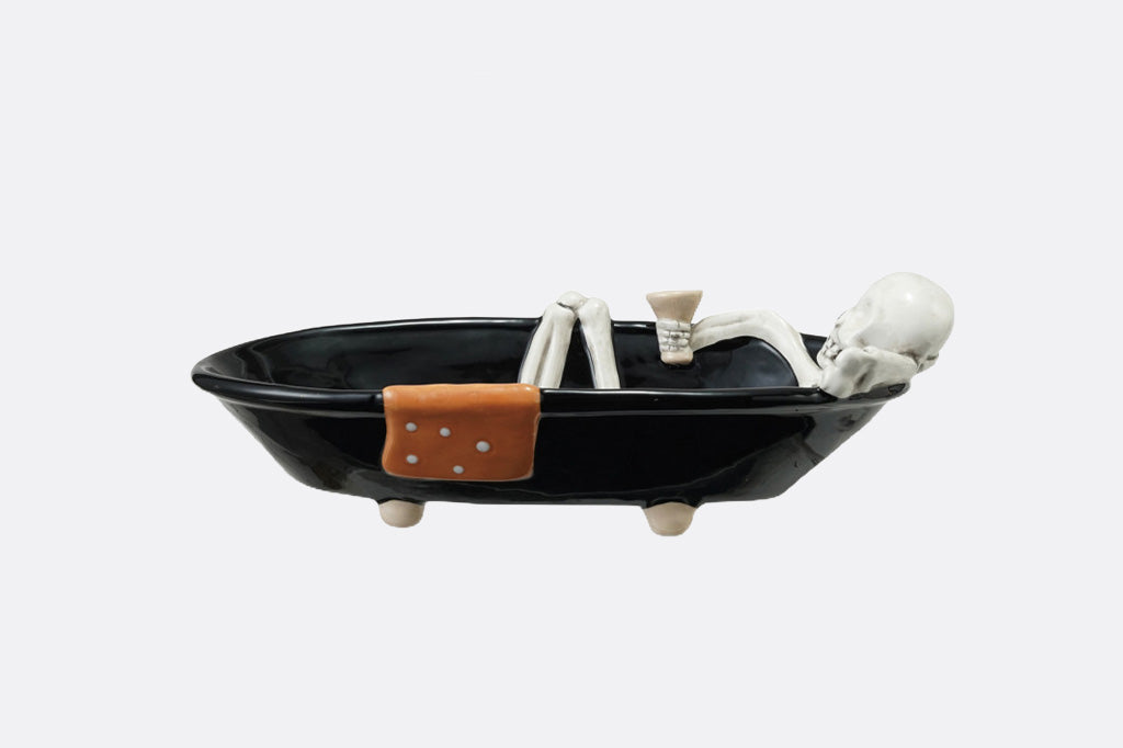 Black bowl with skeleton design on a white background