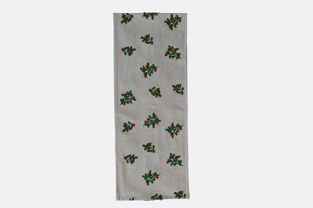 grey table runner with missletoes pictured on a grey background