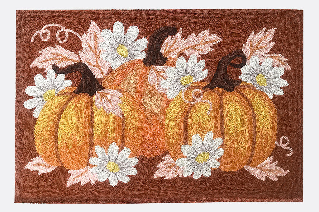 Decorative mat with pumpkins and flowers on a brown background