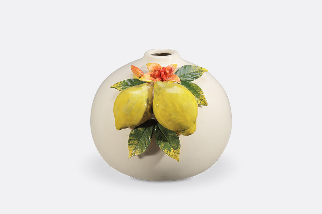 A vase with blossoming lemons.