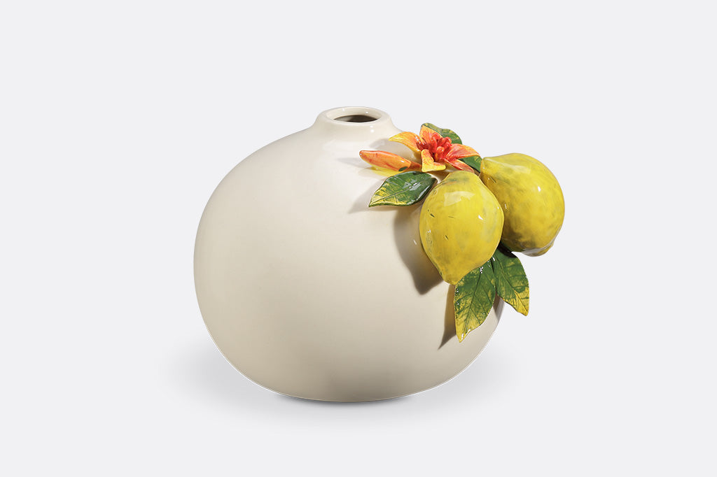 A vase with blossoming lemons.