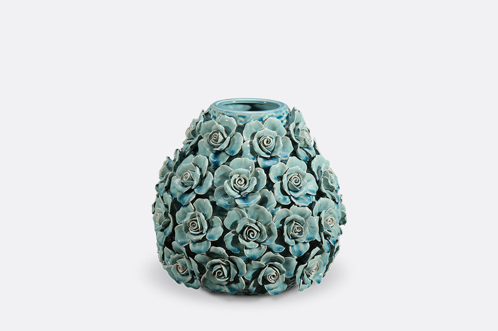 Decorative teal vase with floral patterns