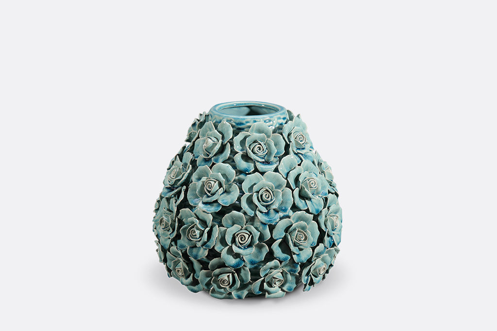 Decorative teal vase with floral patterns