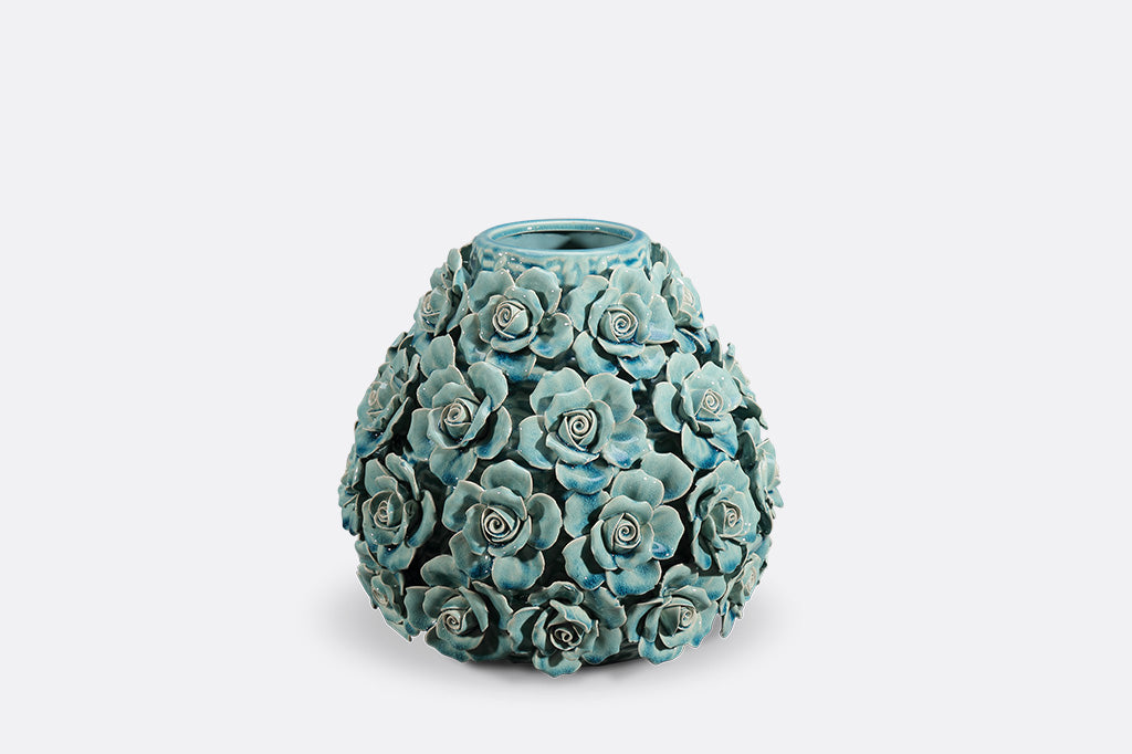 Decorative teal vase with floral patterns