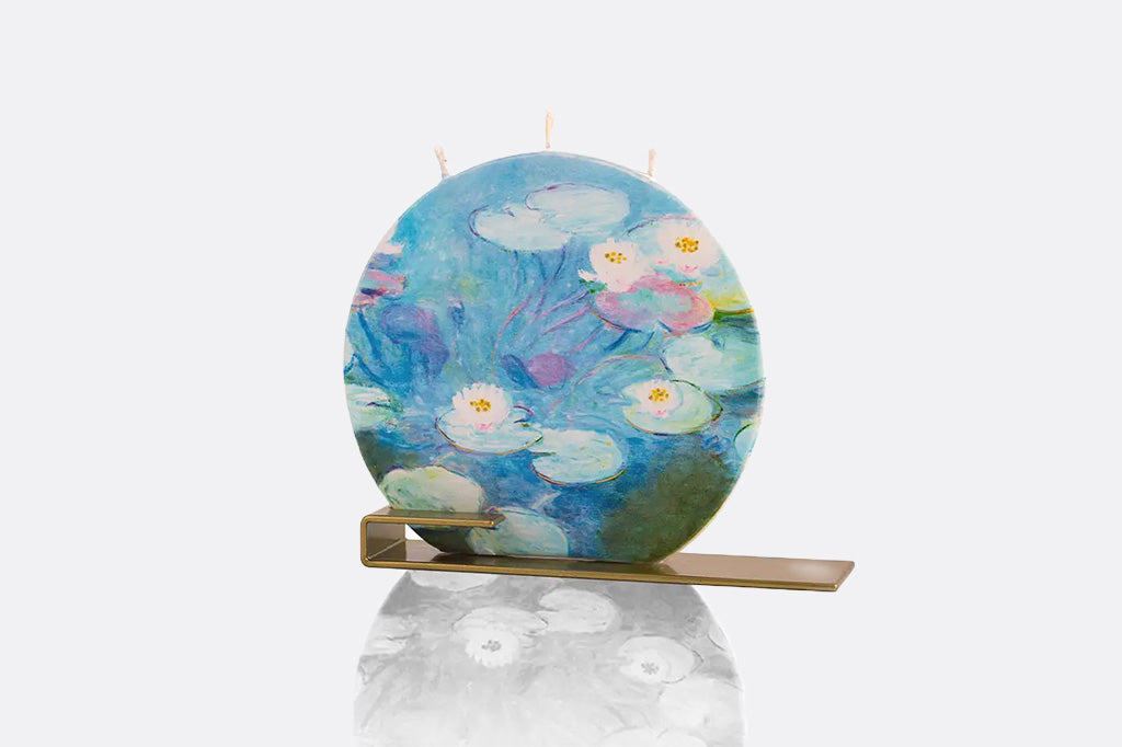 Decorative candle with waterlily design on a white background
