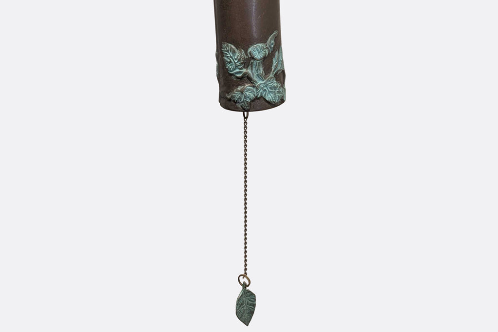 closeup view of detailing on the hand cast brass bell with morning glory relief in verdi finish
