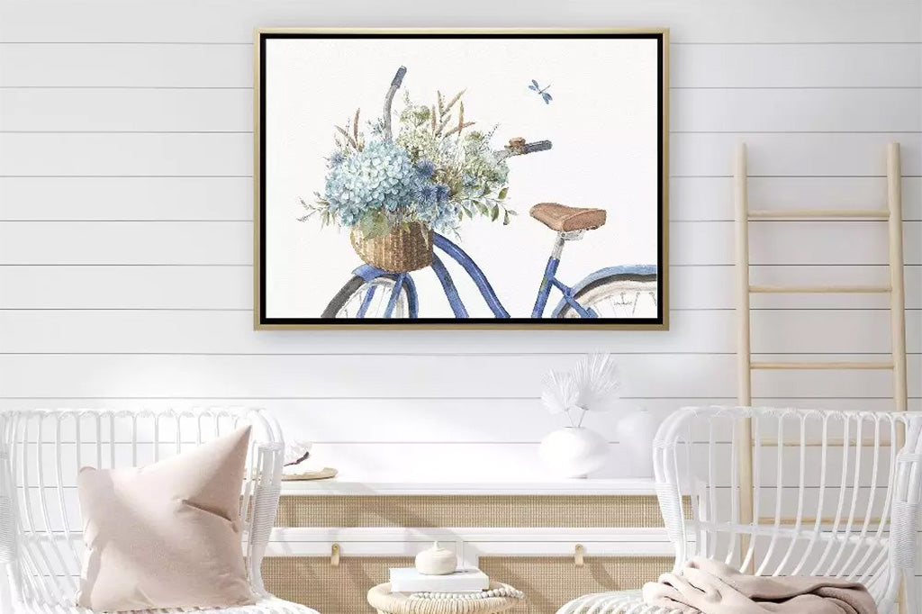 bike basket filled with floral and dragonfly - framed art shown on farmhouse style wall