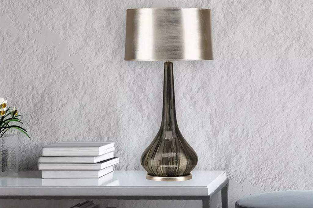 silver barrel lampshade, metallic leafing, charcoal grey pottery base; lamp shown on desk in grey room with plant