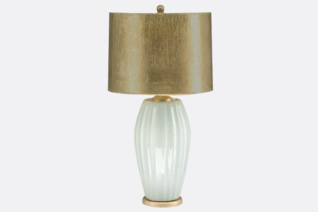 creamy white oval shaped lamp with metallic gold shade
