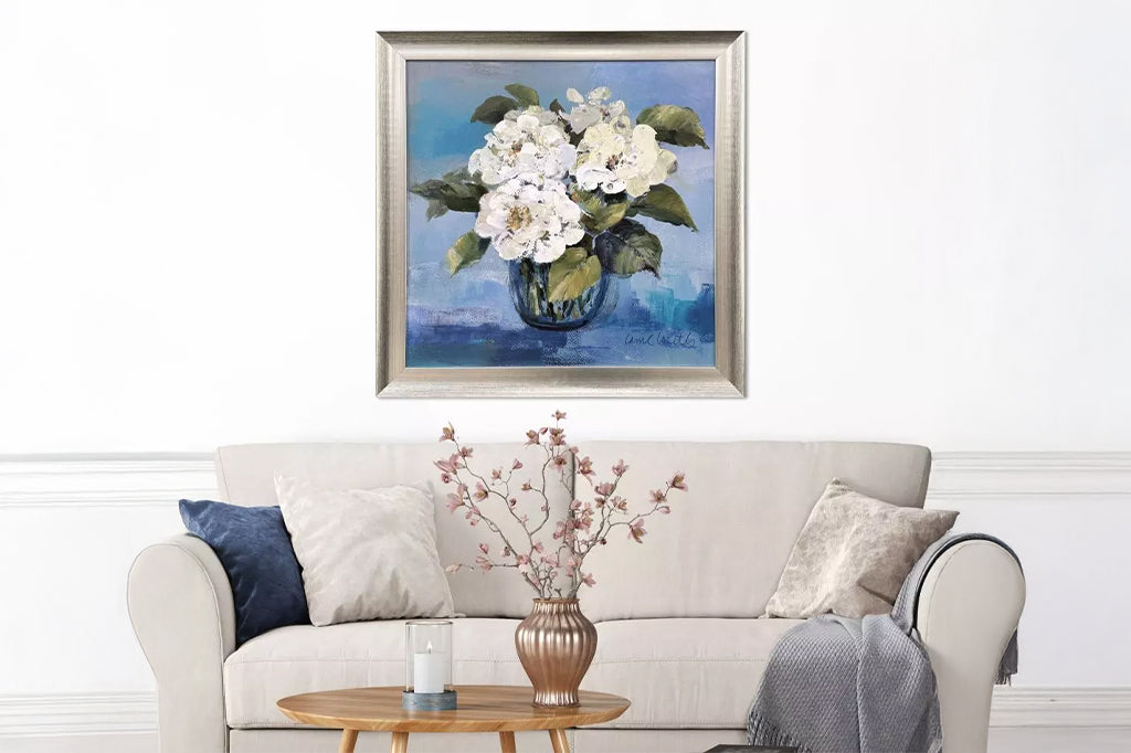 floral framed art on wall above a living room scene