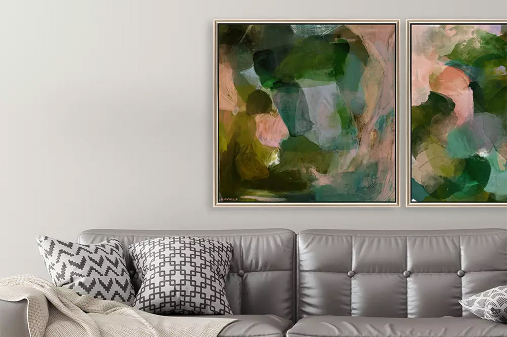 abstract framed art in shades of green and pink mounted on wall with finisher frame with satin black side. Hung above couch in living room scene