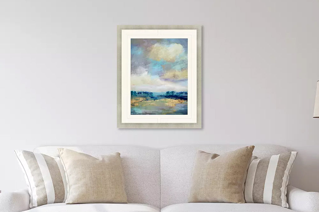 framed art of luscious hues simmer in an ocean of color in champagne frame mounted above a couch in living room scene