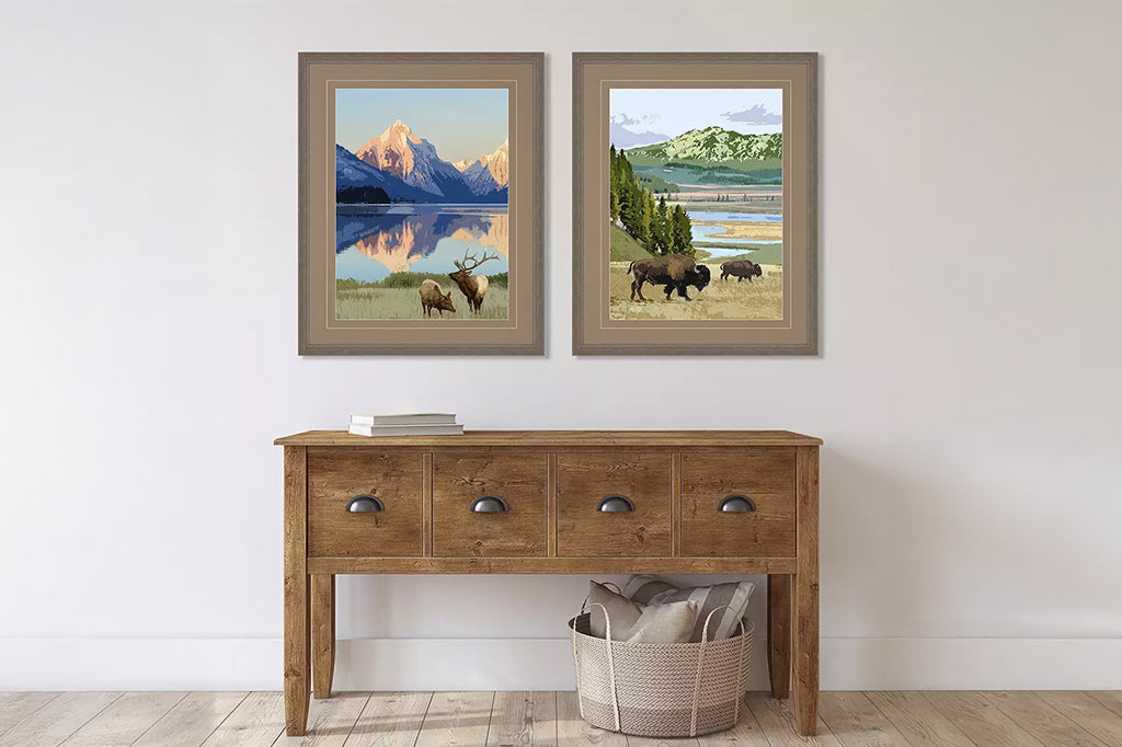 framed artwork of America's national parks, featuring buffalo and moose. Mounted above wooden console table