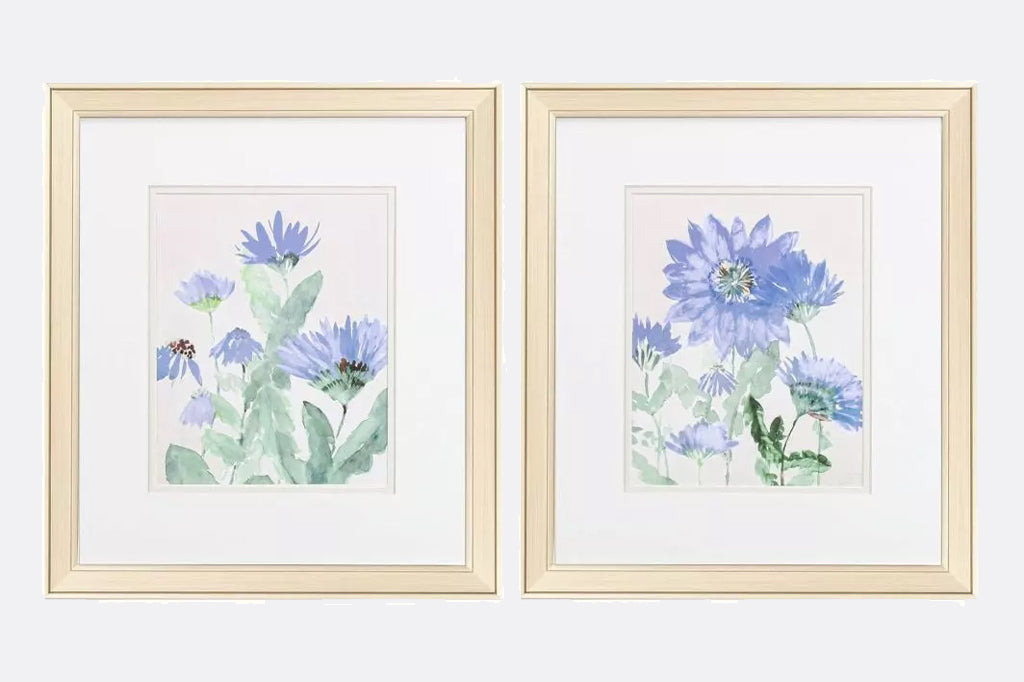 A set of two floral images that are accentuated with double matting. These pieces are framed under glass and paired with a champagne frame.