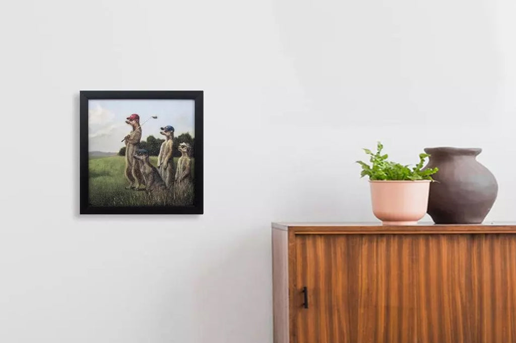 Golfing meerkats framed painting mounted on wall